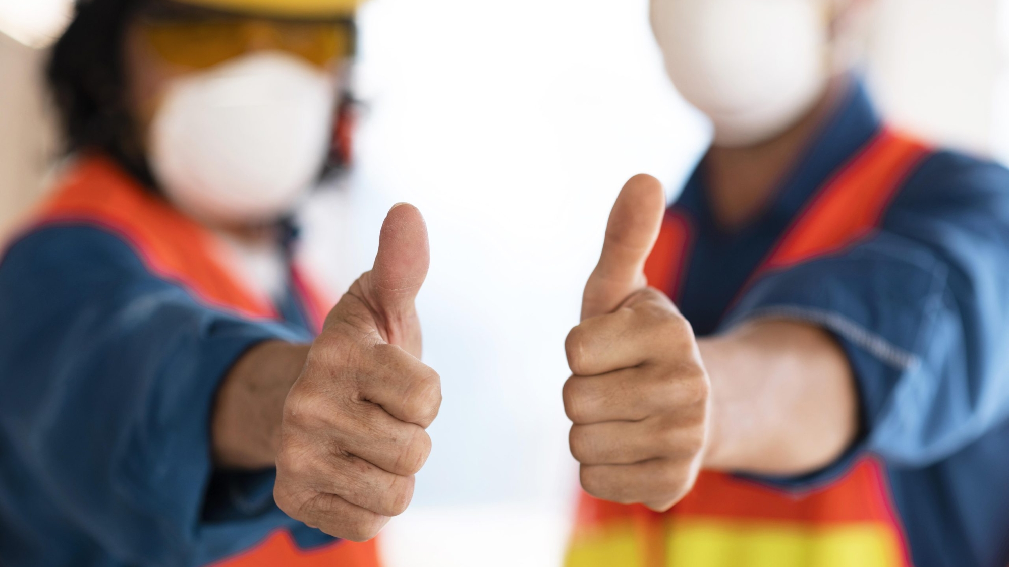 colleagues-with-safety-equipment-showing-ok-sign